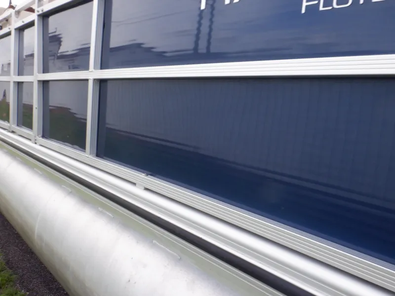 Slide: The Image of 2013 Harris FloteBote Cruiser 240 pontoon boat side view with blue paneling. - 17