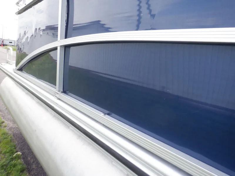 Slide: The Image of 2013 Harris FloteBote Cruiser 240 pontoon boat, side view with blue paneling. - 18