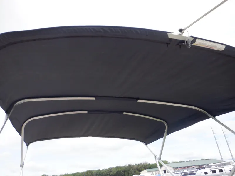 Slide: The Image of Bimini top of 2013 Harris FloteBote Cruiser 240 pontoon boat against cloudy sky. - 19
