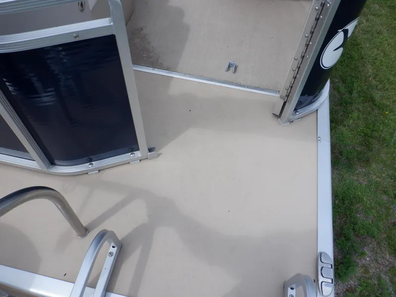 Slide: The Image of 2013 Harris FloteBote Cruiser 240 deck with metal railing and open gate. - 29