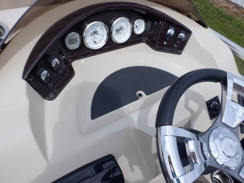 Slide: The Image of Dashboard of 2013 Harris FloteBote Cruiser 240 with gauges and steering wheel. - 32
