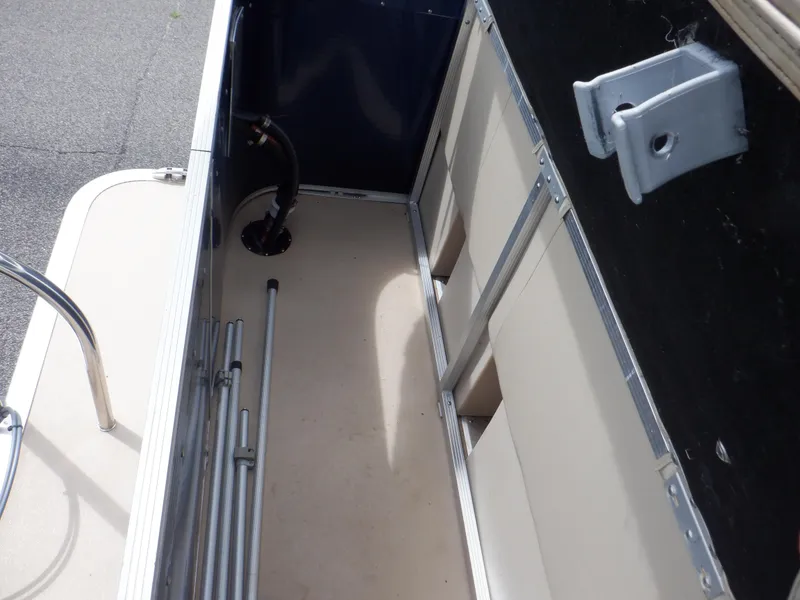 Slide: The Image of 2013 Harris FloteBote Cruiser 240 interior storage compartment with metal frame and beige flooring. - 37