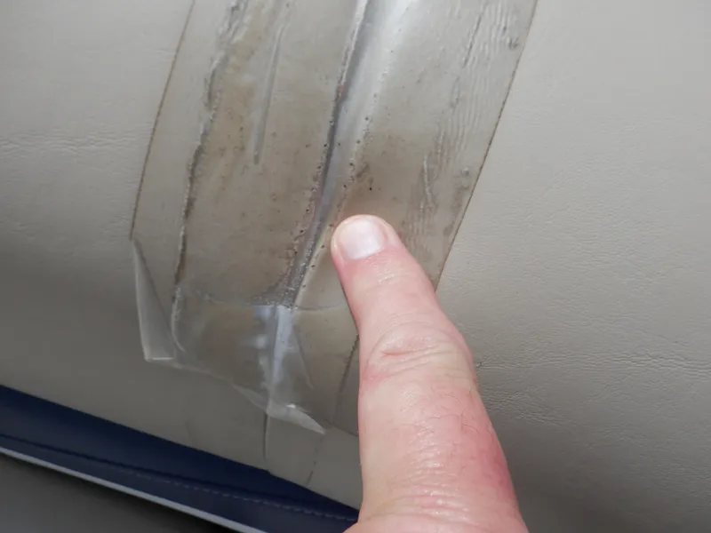 Slide: The Image of Close-up of a finger pointing at a taped seam on a 2013 Harris FloteBote Cruiser 240. - 40