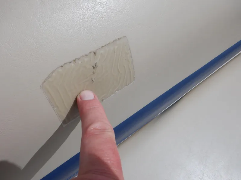 Slide: The Image of Close-up of a finger pointing at a patch on a 2013 Harris FloteBote Cruiser 240. - 41