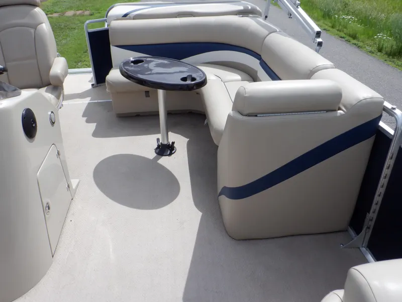 Slide: The Image of 2013 Harris FloteBote Cruiser 240 interior with beige seating and a small table. - 43
