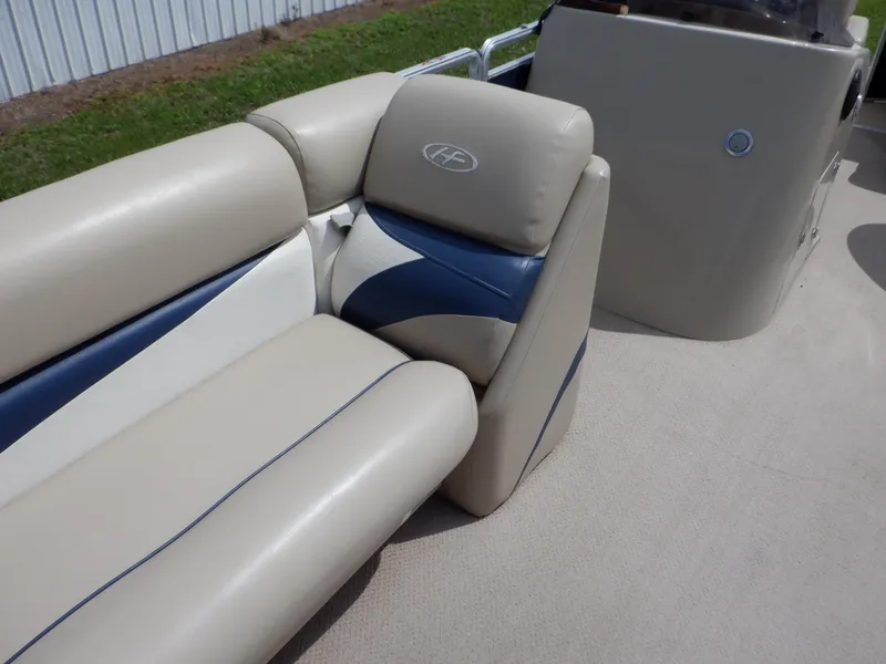 Slide: The Image of 2013 Harris FloteBote Cruiser 240 boat interior with beige and blue seating. - 44