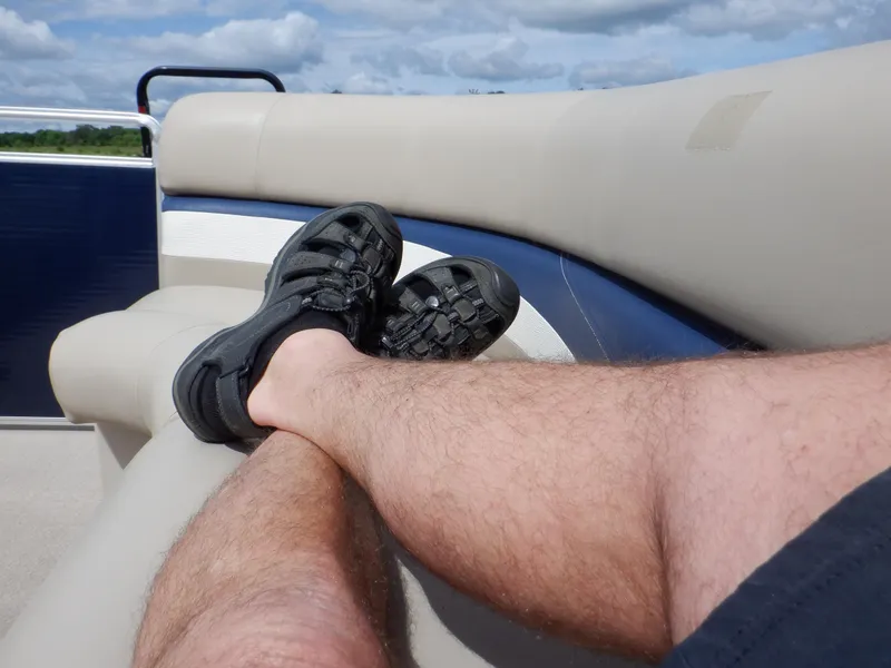 Slide: The Image of Man relaxing on a 2013 Harris FloteBote Cruiser 240 pontoon boat. - 45