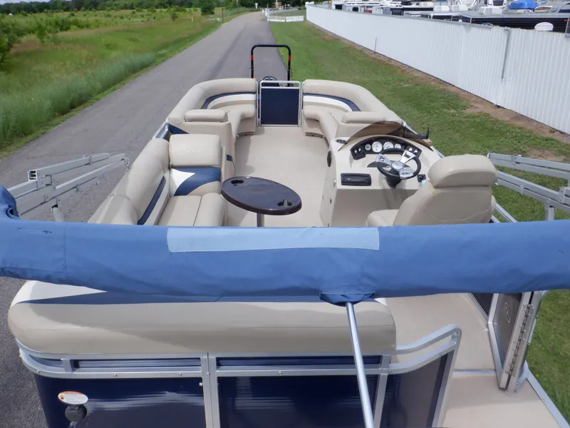Slide: The Image of 2013 Harris FloteBote Cruiser 240 pontoon boat with spacious seating and steering console. - 6