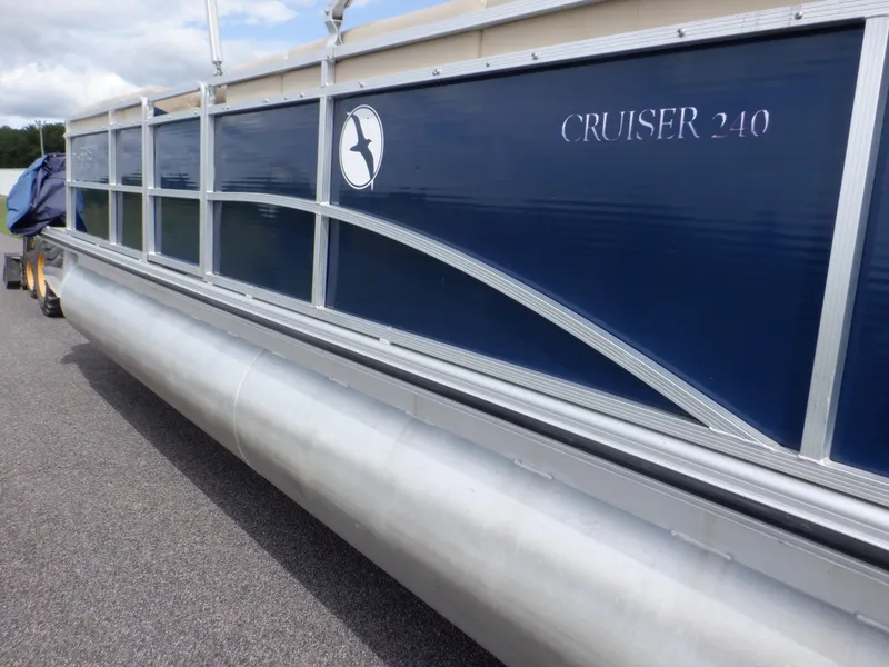 Slide: The Image of 2013 Harris FloteBote Cruiser 240 pontoon boat with blue and silver design. - 9