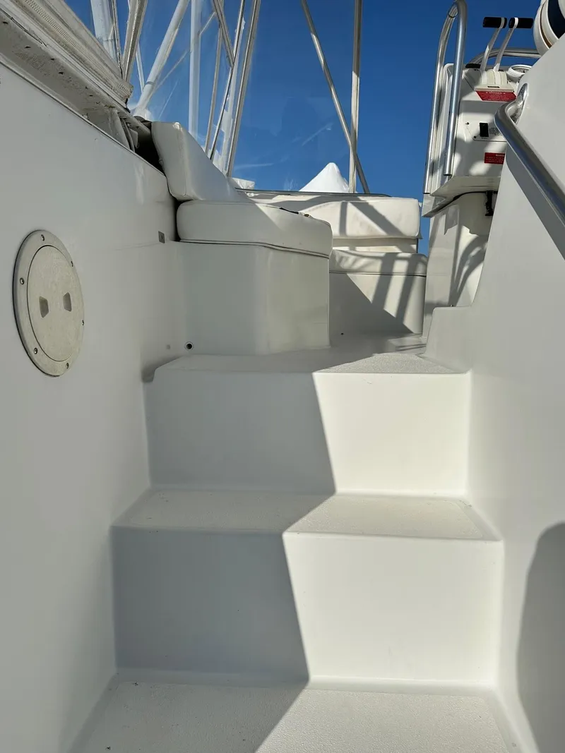 Slide: The Image of Stairs leading to the upper deck of a 1996 Mainship 40 Sedan Bridge yacht. - 10