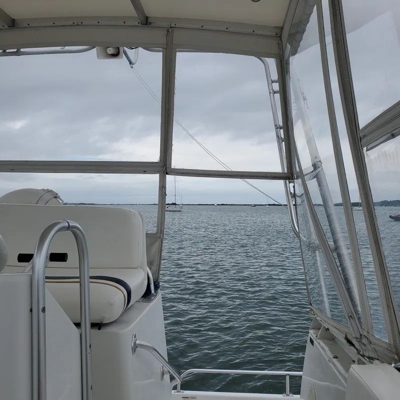 Slide: The Image of 1996 Mainship 40 Sedan Bridge interior view with ocean backdrop. - 11