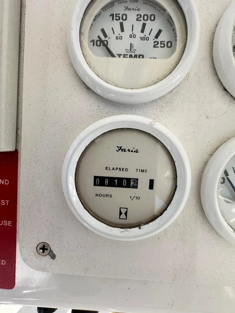 Slide: The Image of 1996 Mainship 40 Sedan Bridge gauge panel showing elapsed time and temperature. - 15