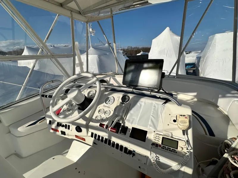 Slide: The Image of 1996 Mainship 40 Sedan Bridge helm with steering wheel, controls, and navigation equipment. - 16