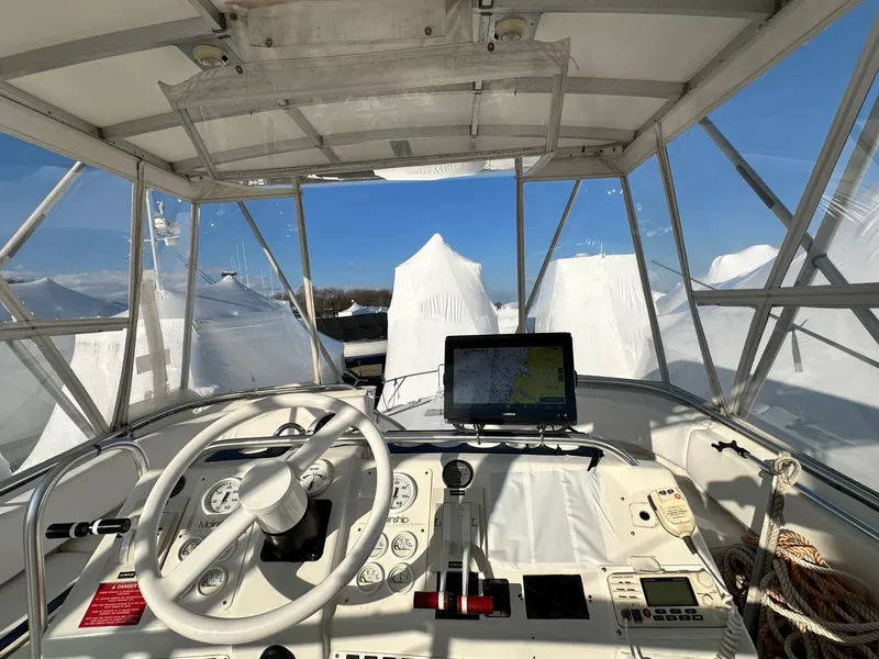 Slide: The Image of 1996 Mainship 40 Sedan Bridge helm with navigation equipment and clear canopy. - 17