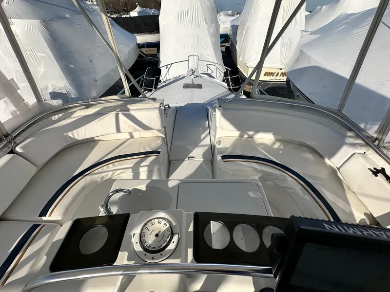 Slide: The Image of 1996 Mainship 40 Sedan Bridge interior with seating and navigation equipment. - 18