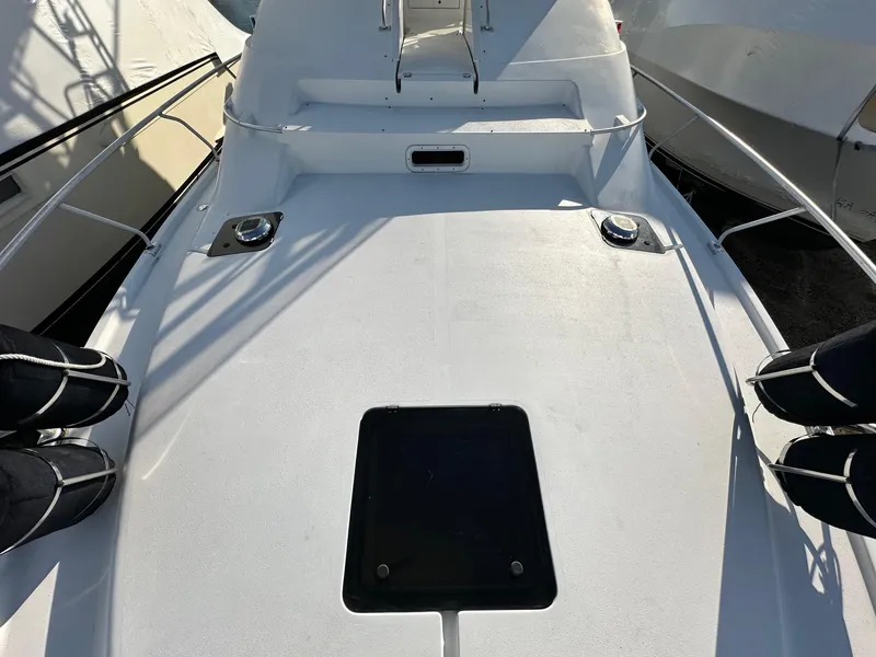 Slide: The Image of 1996 Mainship 40 Sedan Bridge deck with railing and hatch, in bright sunlight. - 26