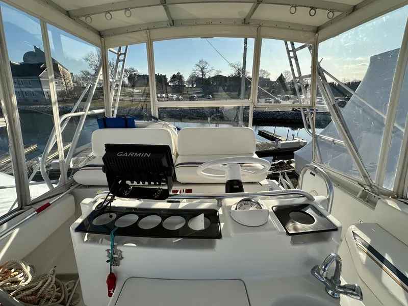 Slide: The Image of 1996 Mainship 40 Sedan Bridge helm with Garmin navigation, docked in a marina. - 29