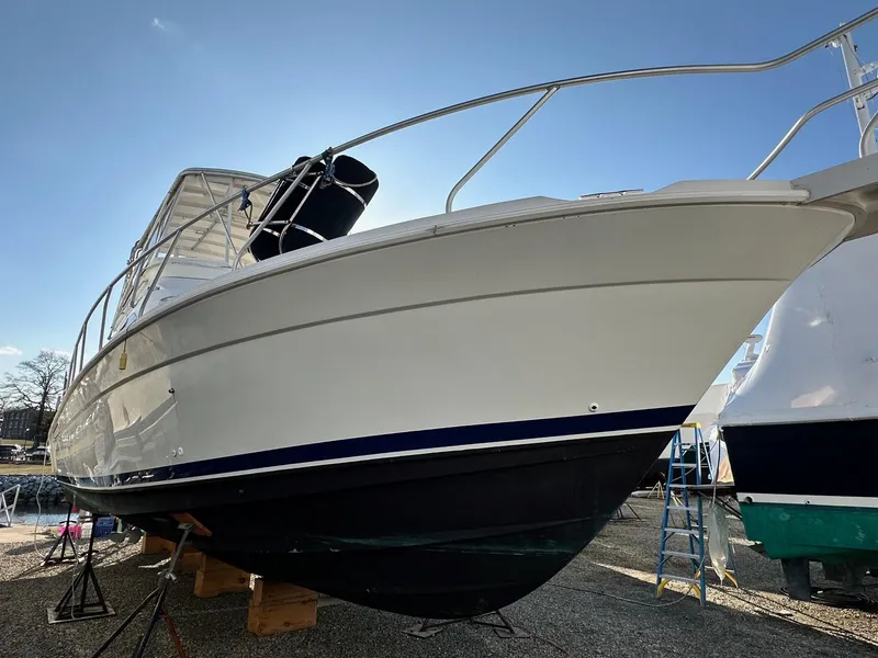 Slide: The Image of 1996 Mainship 40 Sedan Bridge yacht on dry dock, side view under clear sky. - 3