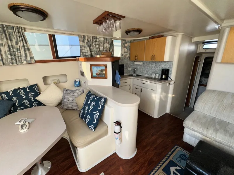 Slide: The Image of Interior of 1996 Mainship 40 Sedan Bridge with cozy seating and compact kitchen. - 39