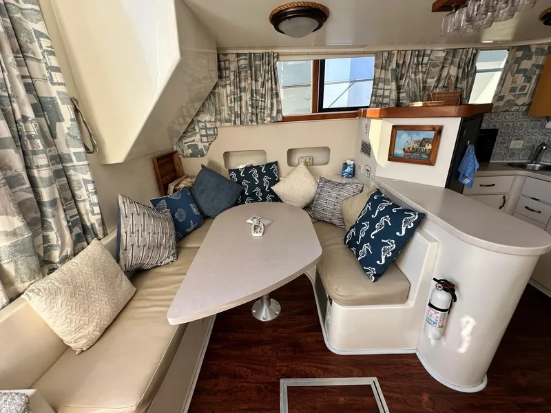 Slide: The Image of Interior of a 1996 Mainship 40 Sedan Bridge with cozy seating and nautical decor. - 40