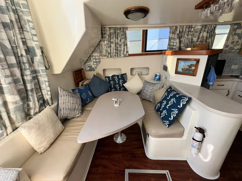 Slide: The Image of 1996 Mainship 40 Sedan Bridge interior with cozy seating and nautical-themed decor. - 41