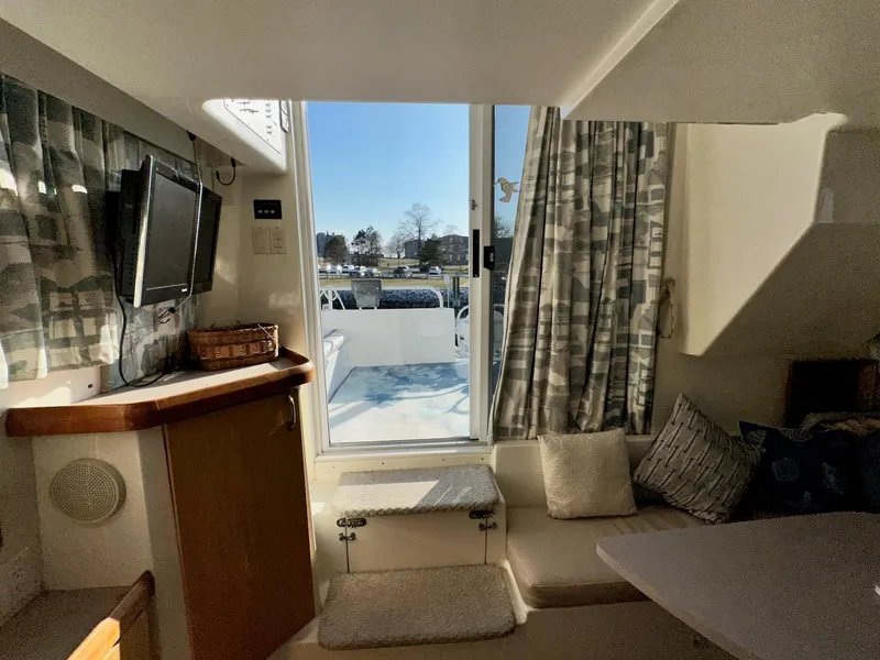 Slide: The Image of Interior of 1996 Mainship 40 Sedan Bridge with cozy seating and outdoor view. - 44