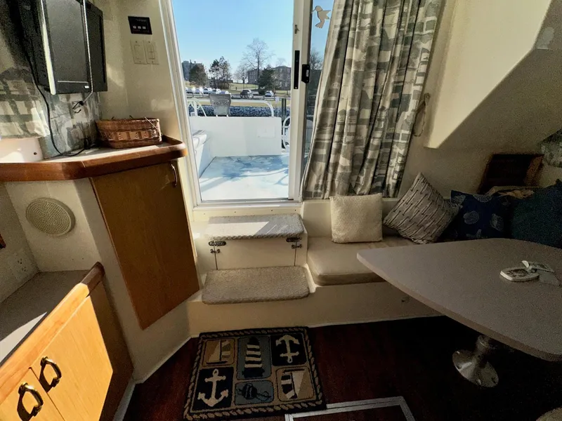 Slide: The Image of Interior of 1996 Mainship 40 Sedan Bridge with cozy seating and nautical decor. - 45