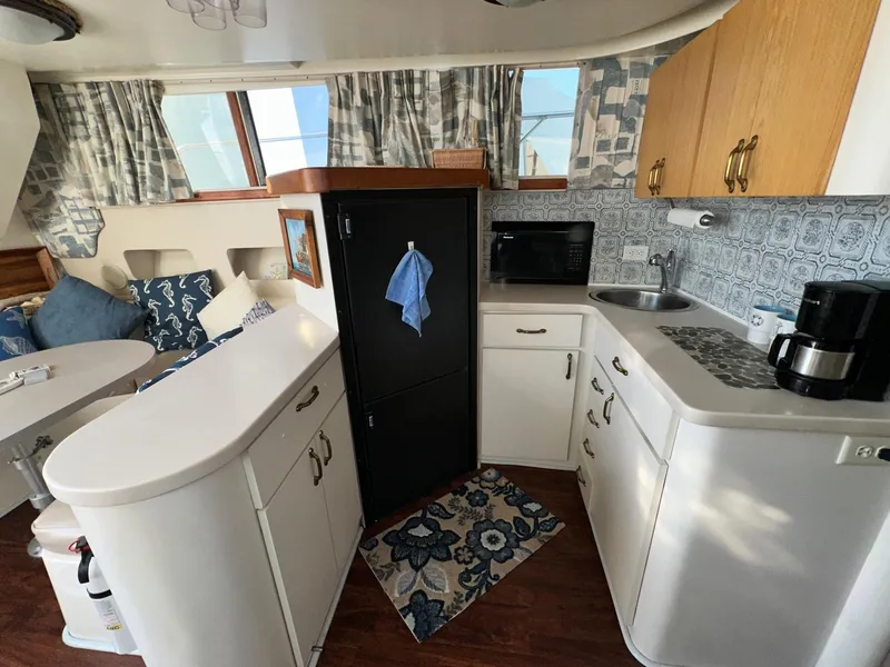 Slide: The Image of Interior of 1996 Mainship 40 Sedan Bridge with kitchen and seating area. - 47