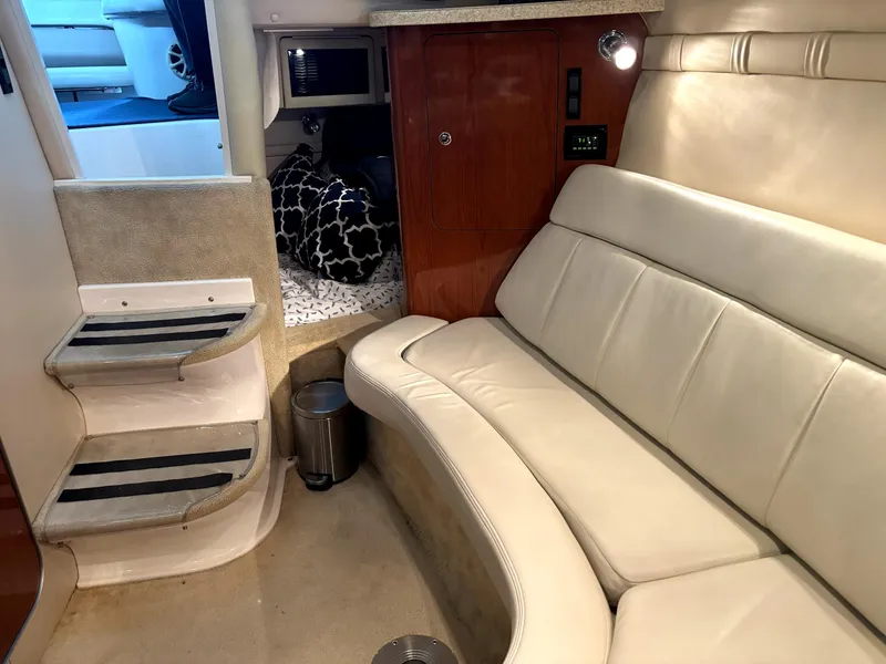 Slide: The Image of 2005 Regal 2860 Express Cruiser interior with beige seating and compact cabin layout. - 15
