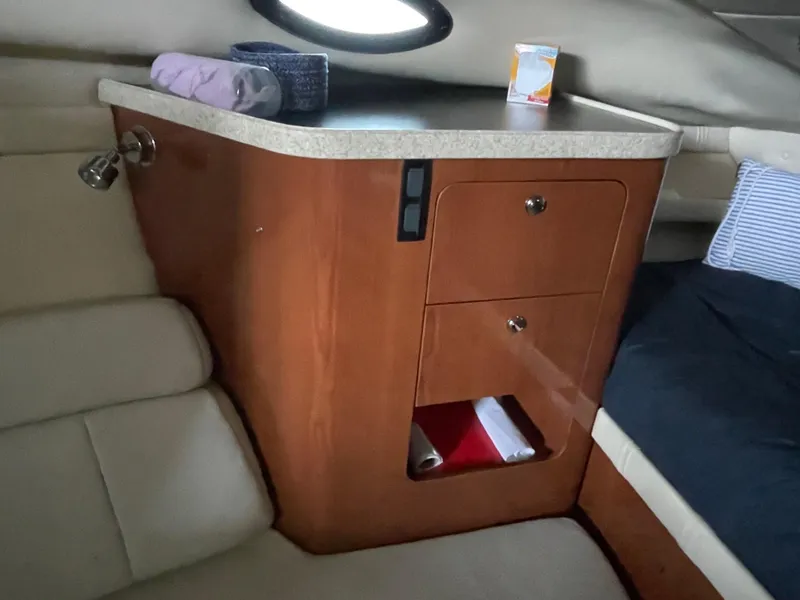Slide: The Image of 2005 Regal 2860 Express Cruiser cabin interior with wooden cabinetry and countertop. - 16