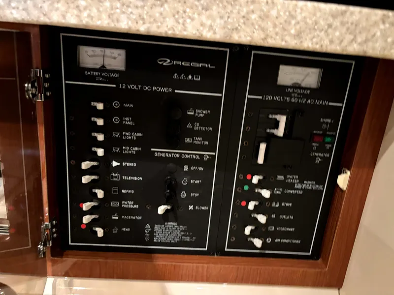 Slide: The Image of Control panel of a 2005 Regal 2860 Express Cruiser boat, featuring power switches and meters. - 17