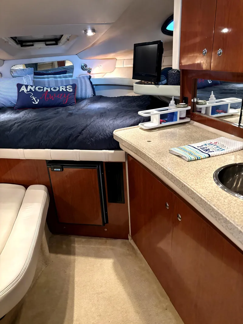 Slide: The Image of 2005 Regal 2860 Express Cruiser interior with bed, kitchenette, and seating area. - 18
