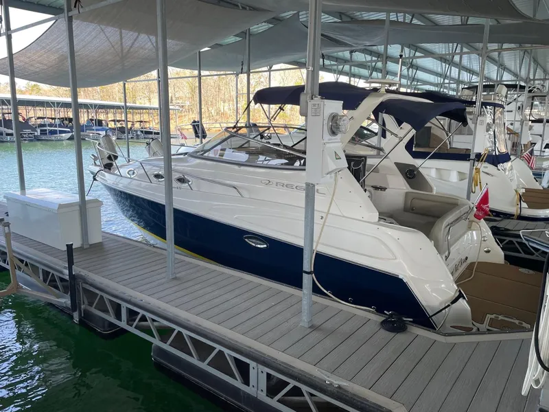 Slide: The Image of 2005 Regal 2860 Express Cruiser docked at marina under canopy. - 2