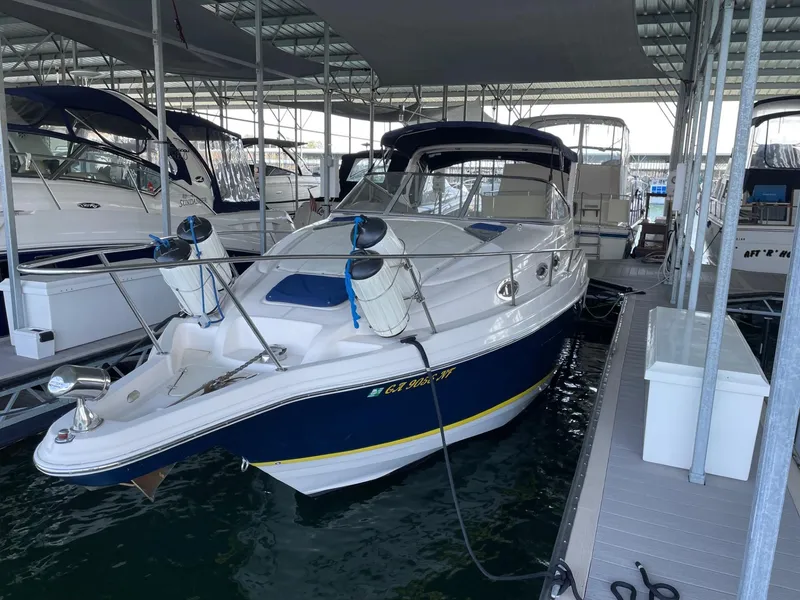 Slide: The Image of 2005 Regal 2860 Express Cruiser docked in a marina under a covered shelter. - 3