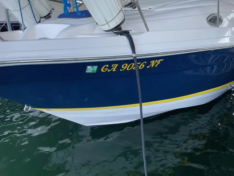 Slide: The Image of 2005 Regal 2860 Express Cruiser docked, displaying registration number GA 9066 NF. - 4