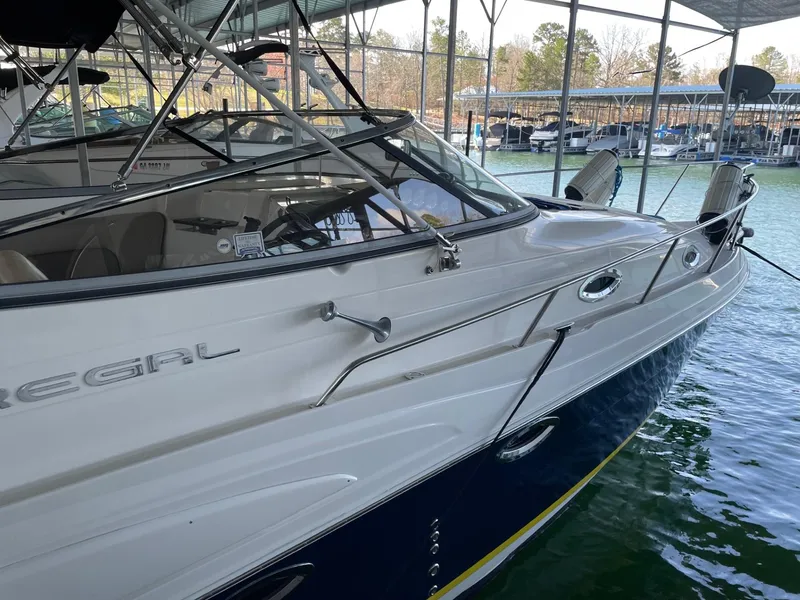 Slide: The Image of 2005 Regal 2860 Express Cruiser docked in a marina, showcasing sleek design and spacious interior. - 7