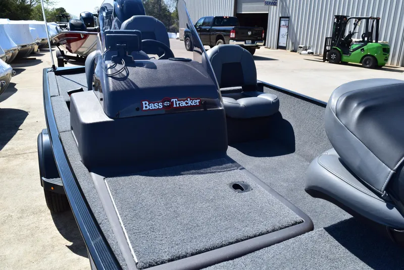 Slide: The Image of 2022 Tracker Bass Tracker Classic XL boat with gray interior, parked outdoors. - 4