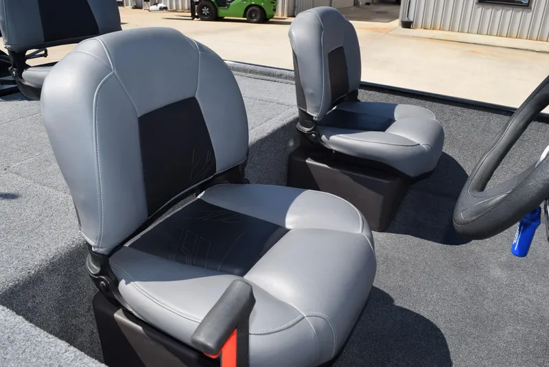 Slide: The Image of 2022 Tracker Bass Tracker Classic XL boat seats, gray and black upholstery, outdoor setting. - 5