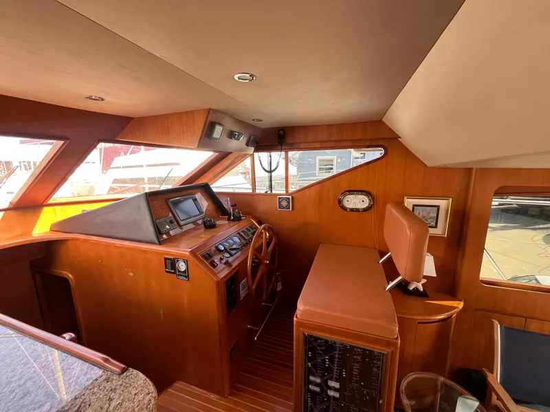 Slide: The Image of 2005 Ocean Alexander 52 Sedan helm with wood finish and navigation equipment. - 11
