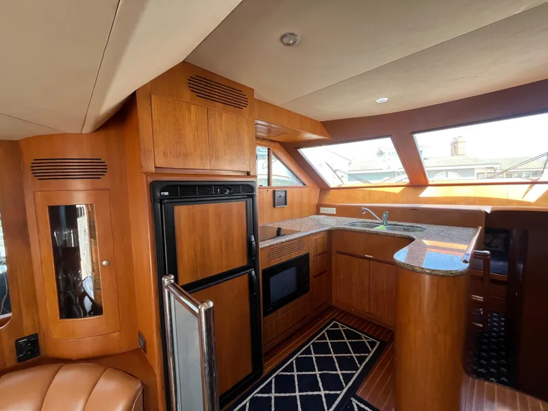 Slide: The Image of Luxurious 2005 Ocean Alexander 52 Sedan yacht interior with modern kitchen and wood finishes. - 12