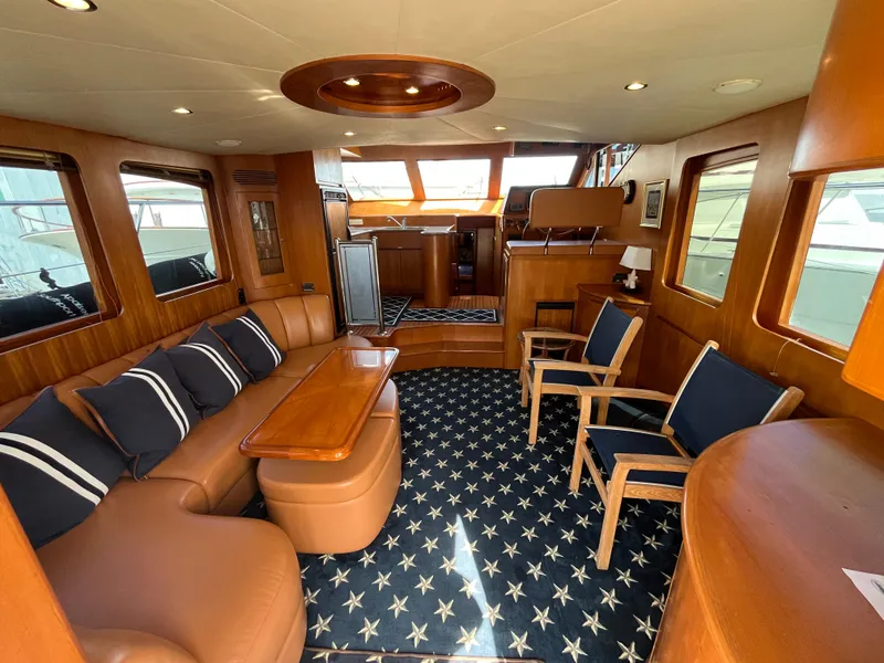 Slide: The Image of Luxurious interior of 2005 Ocean Alexander 52 Sedan yacht with elegant seating and star-patterned carpet. - 13