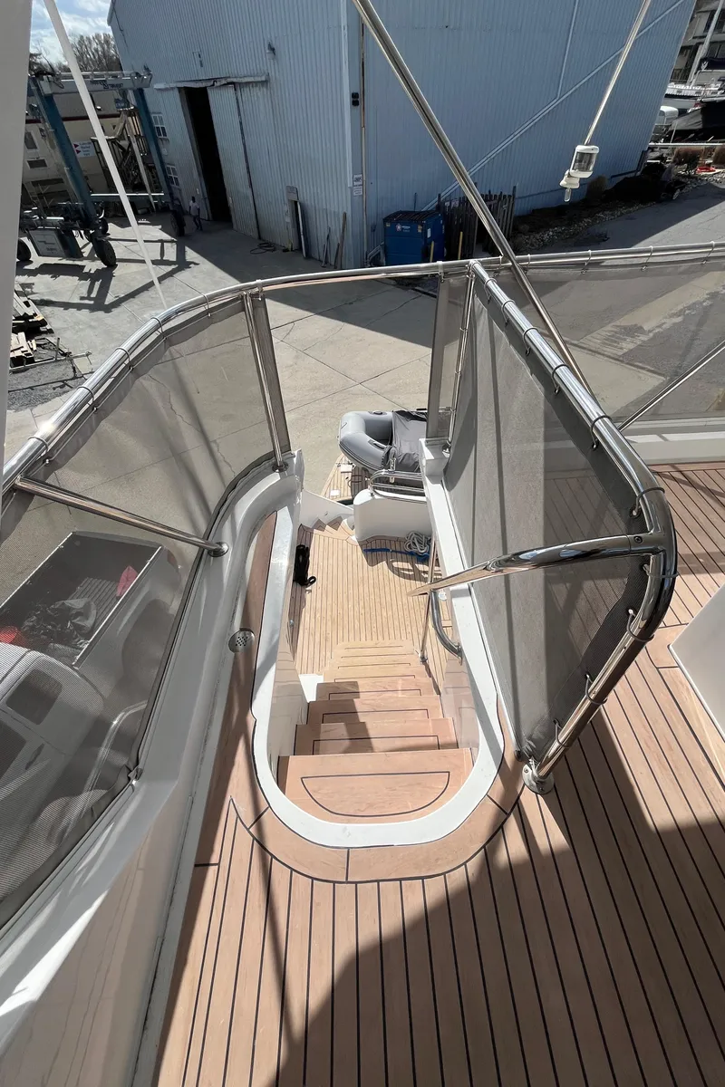 Slide: The Image of 2005 Ocean Alexander 52 Sedan yacht deck with wooden flooring and railing. - 17