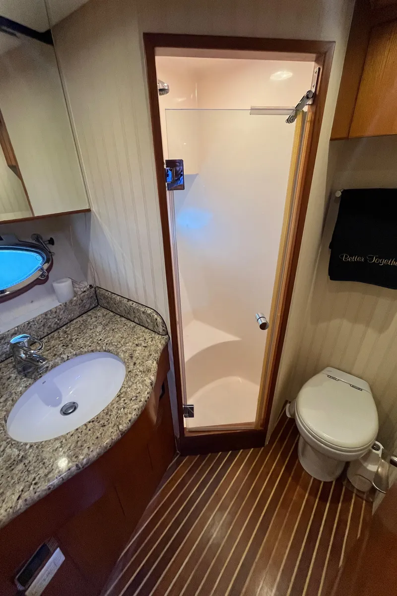 Slide: The Image of 2005 Ocean Alexander 52 Sedan bathroom with granite countertop, shower, and toilet. - 20