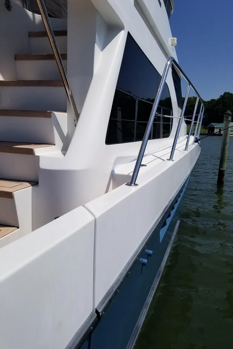 Slide: The Image of 2005 Ocean Alexander 52 Sedan yacht, side view with sleek design and railing. - 29