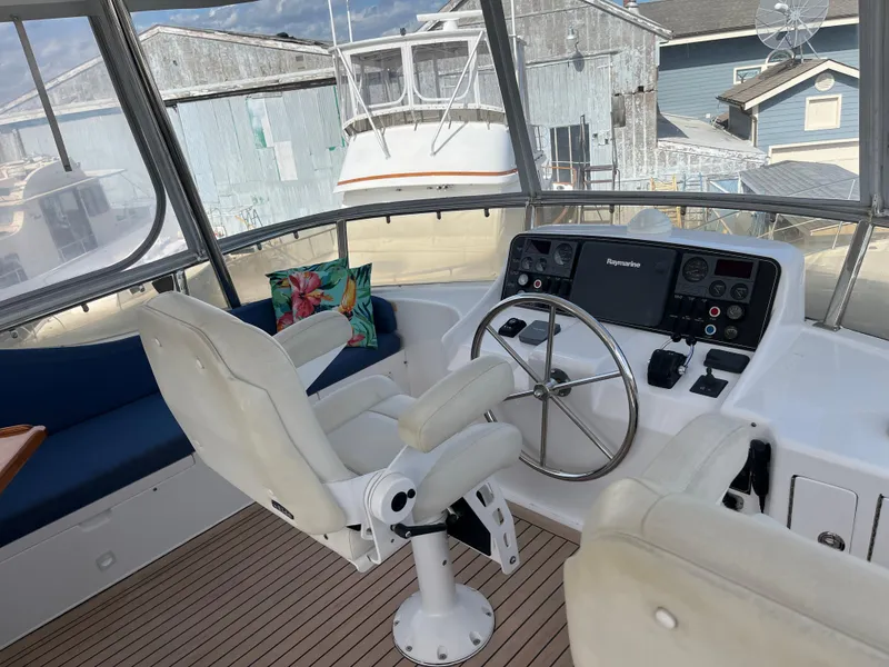 Slide: The Image of Helm of 2005 Ocean Alexander 52 Sedan with steering wheel and navigation controls. - 5