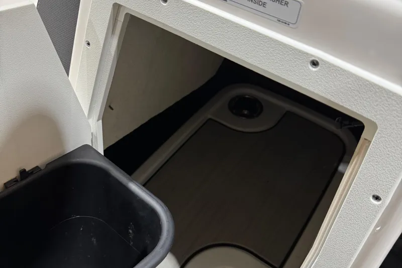 Slide: The Image of Interior storage compartment of 2024 Yamaha Boats 195S, featuring a sleek design. - 14