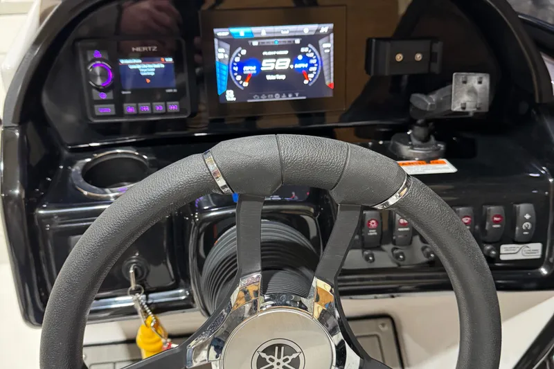 Slide: The Image of 2024 Yamaha Boats 195S dashboard with steering wheel and digital display. - 8