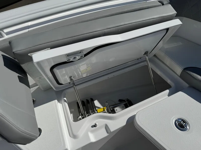Slide: The Image of 2025 Everglades 285 Center Console boat storage compartment with open lid and visible interior. - 11