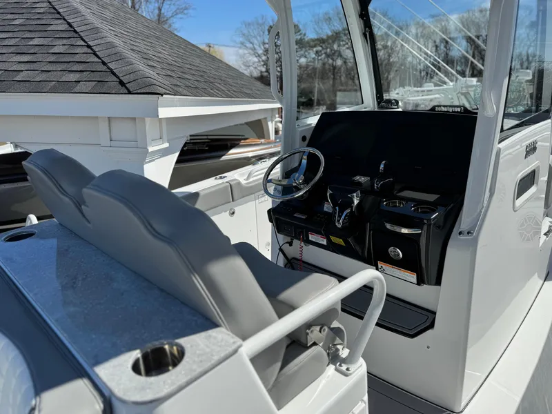 Slide: The Image of 2025 Everglades 285 Center Console boat interior with steering wheel and seating. - 15