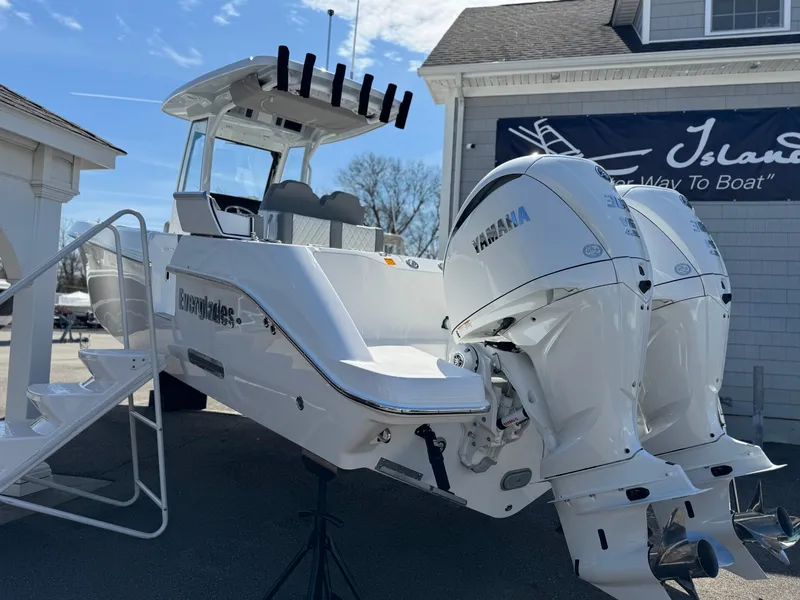 Slide: The Image of 2025 Everglades 285 Center Console boat with dual Yamaha engines displayed outdoors. - 2